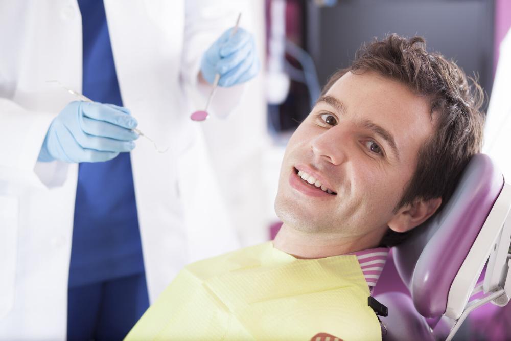 man getting periodontal treatment in Grand Rapids
