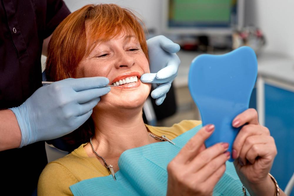 woman sitting in dental chair after a root canal in grand rapids