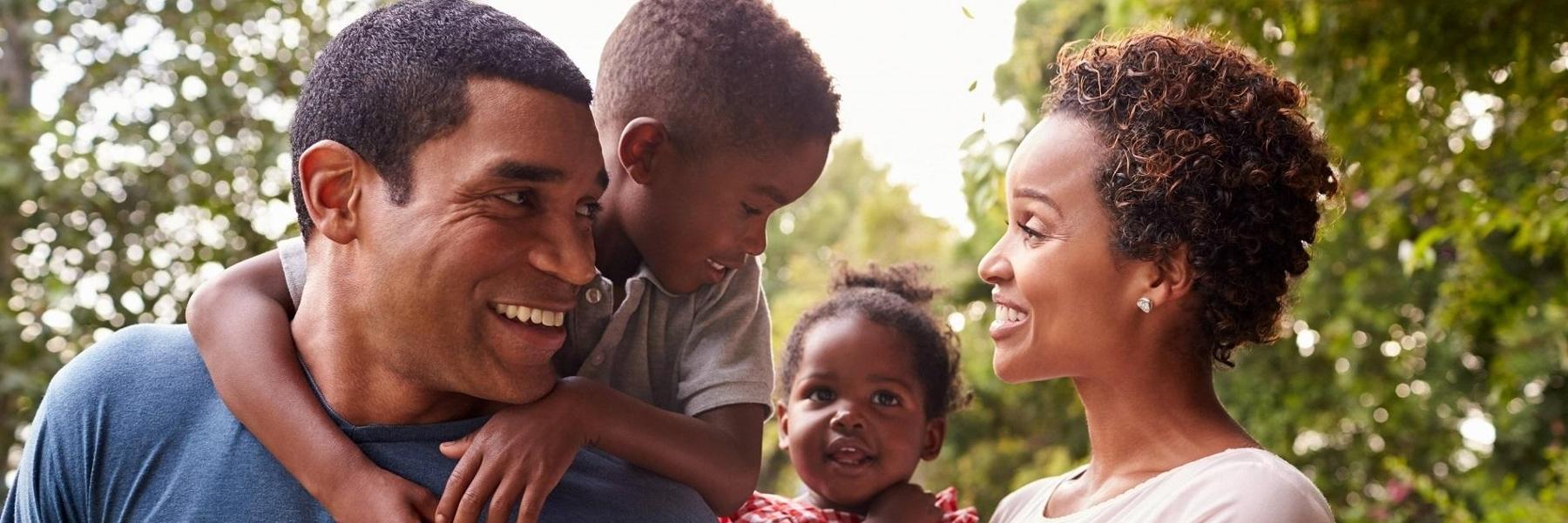 mom, dad, and two kids smiling 