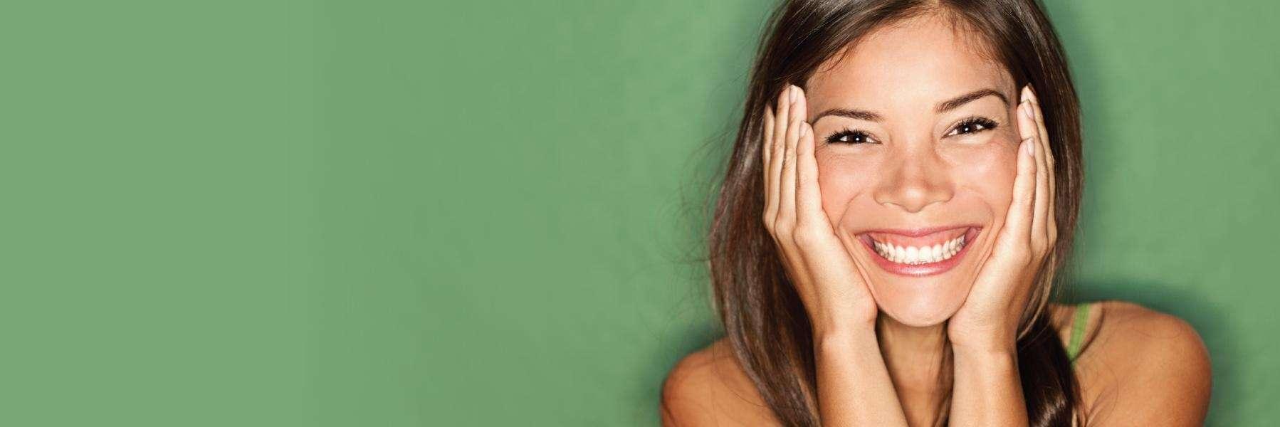 woman smiling after getting periodontal disease treatment
