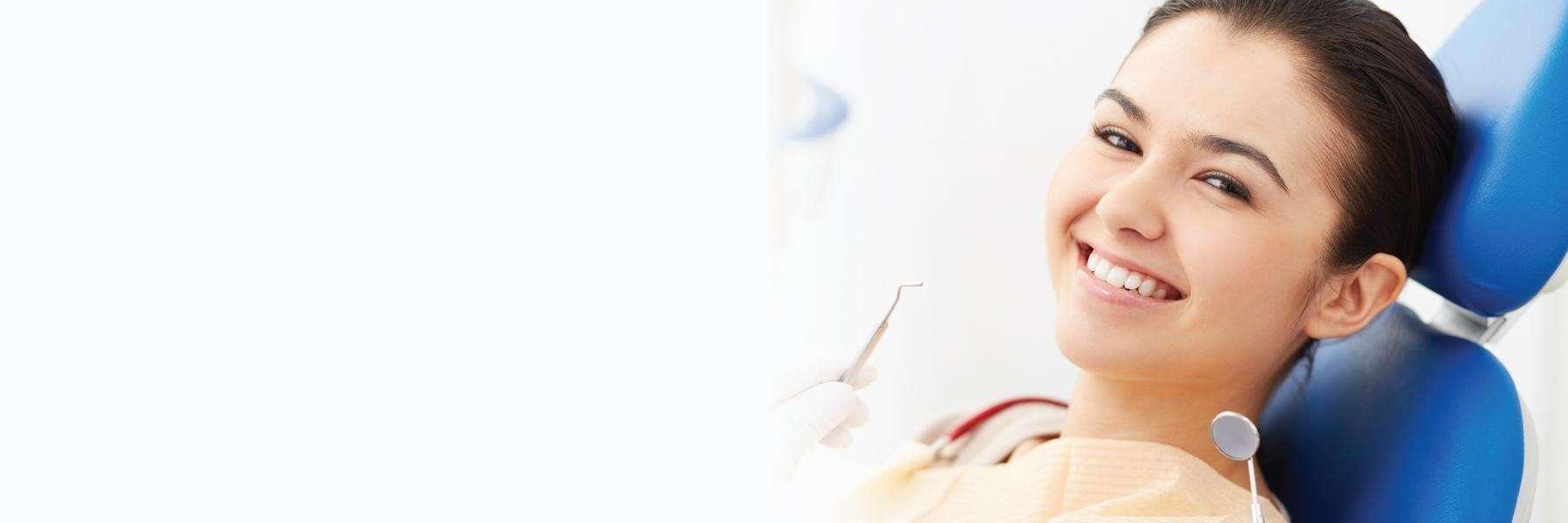 woman smiling in dental chair after gentle root canal in grand rapids